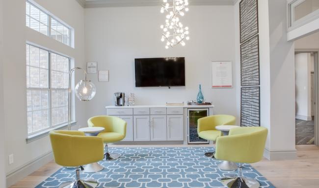 a living room with a tv and chairs