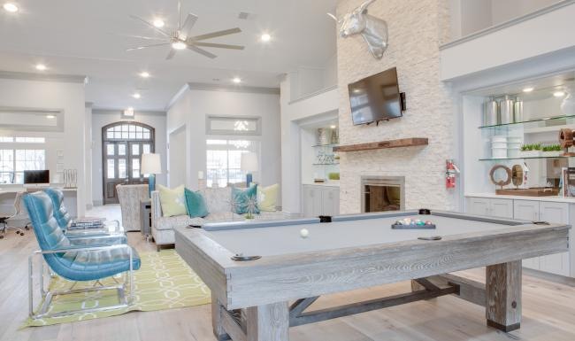 a large living room with a large table and chairs